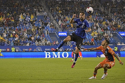 Jul 1, 2023; Montreal, Quebec, CAN; CF Montreal defender Rudy Camacho (4) heads the ball over New York City FC midfielder Santiago Rodriguez (10) in the second half at Stade Saputo. Mandatory Credit: Eric Bolte-USA TODAY Sports