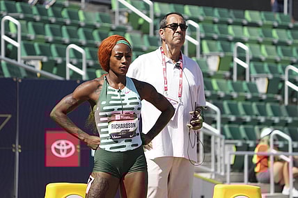 Jul 6, 2023; Eugene, OR, USA; Ventura County deputy attorney general David Glassman stands behind Sha'Carri Richardson during a women's 100m heat at the USATF Championships at Hayward Field. Mandatory Credit: Kirby Lee-USA TODAY Sports