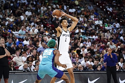 Jul 7, 2023; Las Vegas, NV, USA; San Antonio Spurs forward Victor Wembanyama (1) controls the ball against Charlotte Hornets forward/center Kai Jones (23) during the second half at Thomas & Mack Center. Mandatory Credit: Lucas Peltier-USA TODAY Sports