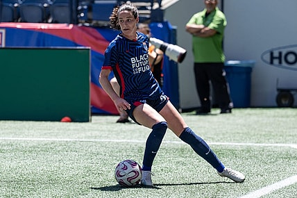 Jul 1, 2023; Seattle, Washington, USA; OL Reign defender Phoebe McClernon (21) gets control of the ball against Racing Louisville at Lumen Field. Mandatory Credit: Stephen Brashear-USA TODAY Sports