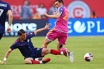 Jul 15, 2023; Chicago, Illinois, USA; Toronto FC defender Shane O'Neill (27) fouls Chicago Fire forward Georgios Koutsias (19) during the first half at Soldier Field. Mandatory Credit: Mike Dinovo-USA TODAY Sports