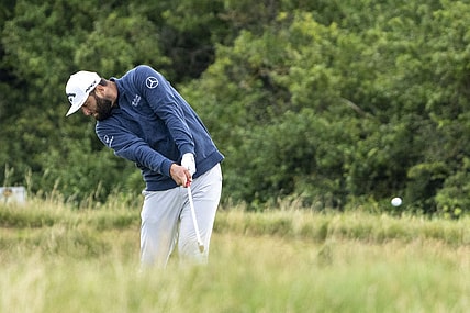 July 17, 2023; Hoylake, ENGLAND, GBR; Jon Rahm hits his fairway shot on the eighth hole during a practice round of The Open Championship golf tournament at Royal Liverpool. Mandatory Credit: Kyle Terada-USA TODAY Sports