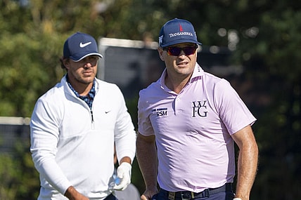 July 17, 2023; Hoylake, ENGLAND, GBR; Brooks Koepka (left) and Zach Johnson (right) watch a tee shot on the fifth hole during a practice round of The Open Championship golf tournament at Royal Liverpool. Mandatory Credit: Kyle Terada-USA TODAY Sports