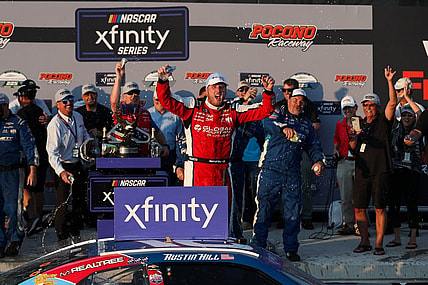 Jul 22, 2023; Long Pond, Pennsylvania, USA; NASCAR Xfinity Series driver Austin Hill celebrates in victory lane after winning the Explore The Pocono Mountains 225 at Pocono Raceway. Mandatory Credit: Matthew O'Haren-USA TODAY Sports