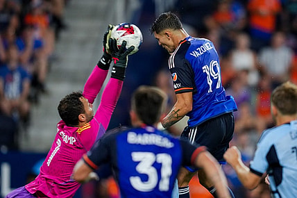Jul 23, 2023; Cincinnati, OH, USA;  Sporting Kansas City goalkeeper John Pulskamp (1) attempts a save against FC Cincinnati forward Brandon Vazquez (19) in the second half at TQL Stadium. Mandatory Credit: Aaron Doster-USA TODAY Sports