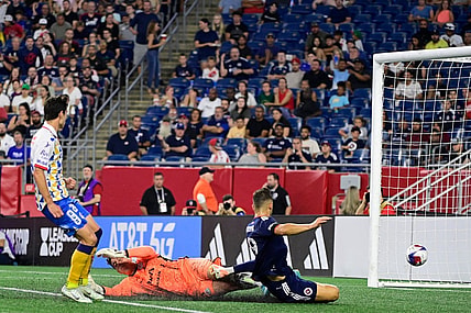 Jul 26, 2023; Foxborough, MA, USA; New England Revolution forward Giacomo Vrioni (9) scores a goal on Club Atletico de San Luis goalkeeper Andres Sanchez (1)  during the second half at Gillette Stadium. Mandatory Credit: Eric Canha-USA TODAY Sports