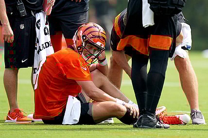 Cincinnati Bengals quarterback Joe Burrow (9) grabs his calf after an injury on a scramble play during NFL football training camp, Thursday, July 27, 2023, in Cincinnati. (Kareem Elgazzar/The Cincinnati Enquirer via AP)