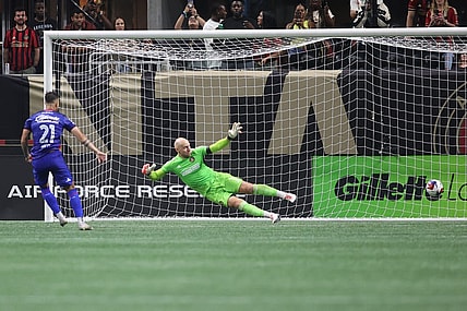Jul 29, 2023; Atlanta, GA, USA; Cruz Azul forward Augusto Lotti (21) scores a goal during penalty shootout against Atlanta United goalkeeper Brad Guzan (1) at Mercedes-Benz Stadium. Mandatory Credit: Brett Davis-USA TODAY Sports