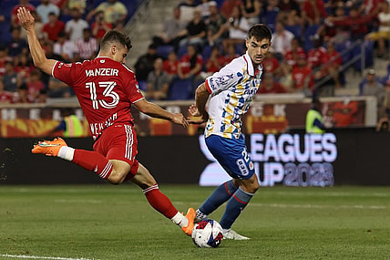 Jul 30, 2023; Harrison, NJ, USA; New York Red Bulls forward Dante Vanzeir (13) shoots the ball in front of Atletico De San Luis defender Pablo Martinez (28) during the second half at Red Bull Arena. Mandatory Credit: Vincent Carchietta-USA TODAY Sports