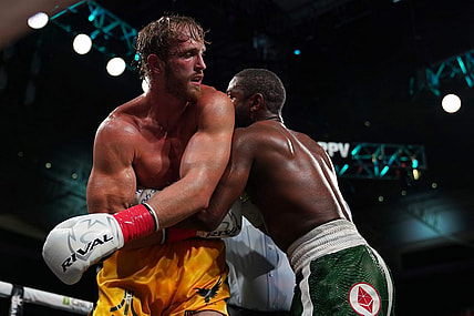 Jun 6, 2021; Miami, Florida, USA; Floyd Mayweather Jr. (Green Trunks) fights Logan Paul (Yellow Trunks) during an exhibition boxing match at Hard Rock Stadium. Mandatory Credit: Jasen Vinlove-USA TODAY Sports