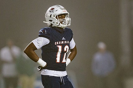 Chaminade-Madonna's Zaquan Patterson (12) walks off the field to meet with his team during a timeout. Chaminade-Madonna shutout Berkeley Prep 21-0 to claim the 3A State Championship title at Gene Cox Stadium on Friday, Dec. 10, 2021.

Second Half Chaminade Madonna V Bp 021