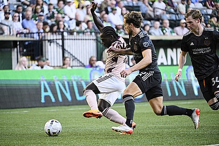 Jun 29, 2022; Portland, Oregon, USA; Houston Dynamo defender Adam Lundqvist (3) defends Portland Timbers forward Yimmi Chara (23) during the first half at Providence Park. The Timbers won 2-1. Mandatory Credit: Troy Wayrynen-USA TODAY Sports