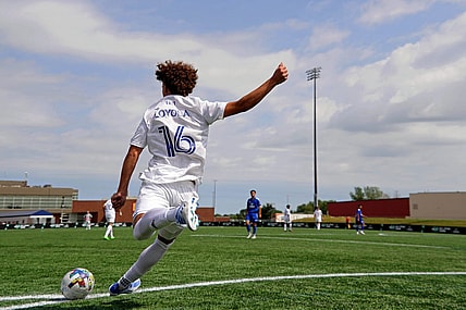 Aug 10, 2022; Blaine, MN, USA; MLS Next East player Favian Loyola (16) of Orlando City takes a corner kick against MLS Next West during the second half of the 2022 MLS NEXT All-Star Game at National Sports Center Indoor Sports Hall. Mandatory Credit: Kirby Lee-USA TODAY Sports