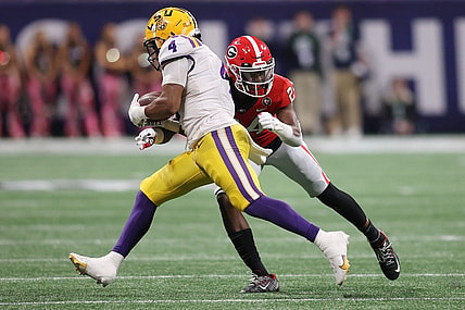Dec 3, 2022; Atlanta, GA, USA; LSU Tigers running back John Emery Jr. (4) is hit following his reception by Georgia Bulldogs defensive back Malaki Starks (24) during the second quarter at Mercedes-Benz Stadium. Mandatory Credit: Brett Davis-USA TODAY Sports