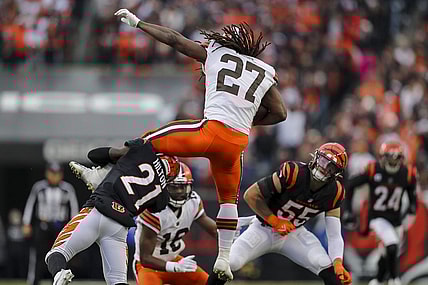 Dec 11, 2022; Cincinnati, Ohio, USA; Cincinnati Bengals cornerback Mike Hilton (21) brings down Cleveland Browns running back Kareem Hunt (27) in the second half at Paycor Stadium. Mandatory Credit: Katie Stratman-USA TODAY Sports