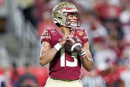 Dec 29, 2022; Orlando, Florida, USA; Florida State Seminoles quarterback Jordan Travis (13) drops back to pass against the Oklahoma Sooners in the second quarter during  the 2022 Cheez-It Bowl at Camping World Stadium. Mandatory Credit: Nathan Ray Seebeck-USA TODAY Sports