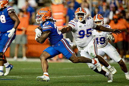 Florida Gators running back Cam Carroll (27) rushes past Florida Gators defensive lineman Jamari Lyons (95) during the second half during the Florida Gators Orange and Blue Spring Game at Steve Spurrier Field at Ben Hill Griffin Stadium in Gainesville, FL on Thursday, April 13, 2023. [Matt Pendleton/Gainesville Sun]

Ncaa Football Florida Gators Orange Blue Spring Game