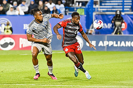 May 13, 2023; Montreal, Quebec, CAN; CF Montreal forward Chinonso Offor (9) and Toronto FC defender Richie Laryea (22) during the first half at Stade Saputo. Mandatory Credit: David Kirouac-USA TODAY Sports