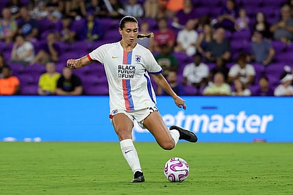 Jul 7, 2023; Orlando, Florida, USA; OL Reign midfielder Olivia Van der Jagt (33) kicks the ball against the Orlando Pride during the second half at Exploria Stadium. Mandatory Credit: Mike Watters-USA TODAY Sports