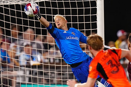 Jul 15, 2023; Commerce City, Colorado, USA; Colorado Rapids goalkeeper William Yarbrough (22) makes an incredible save against the Houston Dynamo FC during the second half at Dick's Sporting Goods Park. Mandatory Credit: Ron Chenoy-USA TODAY Sports