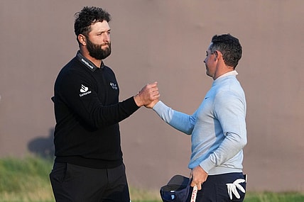 July 20, 2023; Hoylake, England, GBR; Jon Rahm (left) and Rory McIlroy shake hands after completing their first round of The Open Championship golf tournament at Royal Liverpool. Mandatory Credit: Kyle Terada-USA TODAY Sports