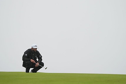 Jul 23, 2023; Hoylake, England, GBR; Jon Rahm lines up a putt on the 13th green during the final round of The Open Championship golf tournament. Mandatory Credit: Kyle Terada-USA TODAY Sports