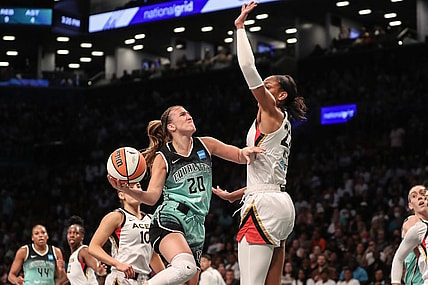 Aug 6, 2023; Brooklyn, New York, USA;  New York Liberty guard Sabrina Ionescu (20) looks to drive past Las Vegas Aces forward A'ja Wilson (22) in the first quarter at Barclays Center. Mandatory Credit: Wendell Cruz-USA TODAY Sports