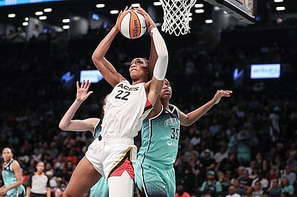 Aug 6, 2023; Brooklyn, New York, USA; Las Vegas Aces forward A'ja Wilson (22) grabs a rebound in front of New York Liberty forward Jonquel Jones (35) in the third quarter at Barclays Center. Mandatory Credit: Wendell Cruz-USA TODAY Sports