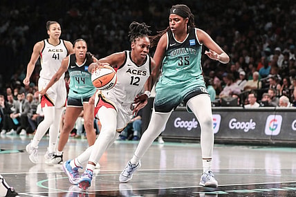 Aug 6, 2023; Brooklyn, New York, USA;  Las Vegas Aces guard Chelsea Gray (12) looks to drive past New York Liberty forward Jonquel Jones (35) in the third quarter at Barclays Center. Mandatory Credit: Wendell Cruz-USA TODAY Sports