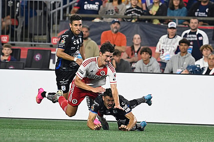 Aug 7, 2023; Foxborough, MA, USA; New England Revolution forward Jozy Altidore (14) (red) and Queretaro FC midfielder Federico Lertora (14) (black) get tangled  during the second half at Gillette Stadium. Mandatory Credit: Eric Canha-USA TODAY Sports
