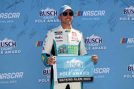 Aug 19, 2023; Watkins Glen, New York, USA; NASCAR Cup Series driver Denny Hamlin stands with the Busch Light Pole Award after winning the pole for the Go Bowling at The Glen at Watkins Glen International. Mandatory Credit: Matthew O'Haren-USA TODAY Sports