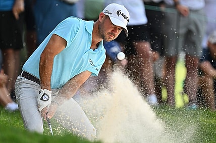 Aug 20, 2023; Olympia Fields, Illinois, USA; Brian Harman hits out of a bunker on the 2nd green during the final round of the BMW Championship golf tournament. Mandatory Credit: Jamie Sabau-USA TODAY Sports