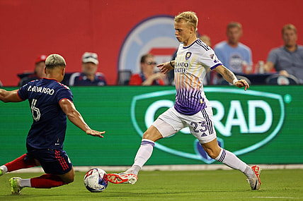 Aug 20, 2023; Chicago, Illinois, USA; Chicago Fire defender Miguel Angel Navarro (6) slide tackles against Orlando City midfielder Dagur Dan Thorhallsson (23) during the first half at Soldier Field. Mandatory Credit: Jon Durr-USA TODAY Sports