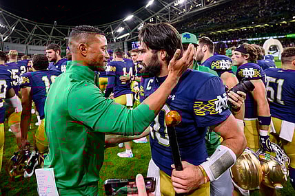 Aug 26, 2023; Dublin, IRL; Notre Dame Fighting Irish head coach Marcus Freeman, left, celebrates with quarterback Sam Hartman (10) after Notre Dame defeated the Navy Midshipmen 42-3 at Aviva Stadium. Mandatory Credit: Matt Cashore-USA TODAY Sports