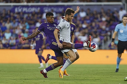 Aug 26, 2023; Orlando, Florida, USA; Orlando City SC midfielder Wilder Cartagena (16) and St. Louis City SC midfielder Indiana Vassilev (19) battle for the ball in the first half at Exploria Stadium. Mandatory Credit: Morgan Tencza-USA TODAY Sports