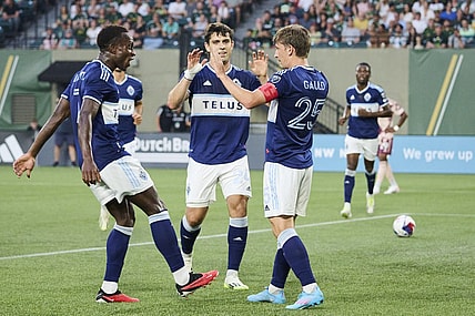 Aug 26, 2023; Portland, Oregon, USA; Vancouver Whitecaps midfielder Ryan Gauld (25) celebrates with teammates after scoring a goal in the first half against the Portland Timbers at Providence Park. Mandatory Credit: Troy Wayrynen-USA TODAY Sports