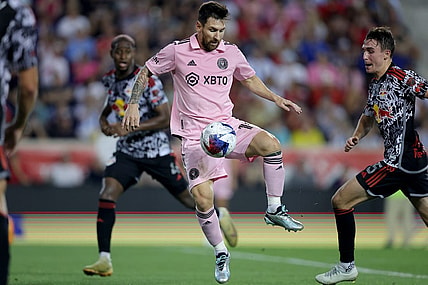 Aug 26, 2023; Harrison, New Jersey, USA; Inter Miami CF forward Lionel Messi (10) controls the ball against New York Red Bulls defender Andres Reyes (4) and midfielder Peter Stroud (5) during the second half at Red Bull Arena. Mandatory Credit: Brad Penner-USA TODAY Sports