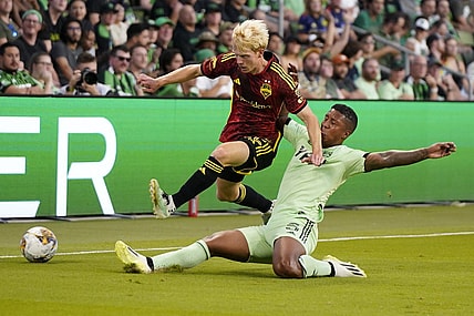 Aug 30, 2023; Austin, Texas, USA; Seattle Sounders midfielder Ethan Dobbelaere (45) is tackled by Austin FC midfielder Jhojan Valencia (5) at Q2 Stadium. Mandatory Credit: Scott Wachter-USA TODAY Sports