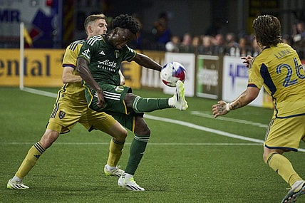Aug 30, 2023; Portland, Oregon, USA; Portland Timbers midfielder Santiago Moreno (30) kicks the ball during the first half against Real Salt Lake defender Andrew Brody (2) at Providence Park. Mandatory Credit: Troy Wayrynen-USA TODAY Sports