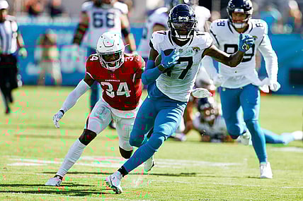 Sep 26, 2021; Jacksonville, Florida, USA;  Jacksonville Jaguars wide receiver D.J. Chark (17) runs with the ball while being chased by Arizona Cardinals defensive back Jalen Thompson (34) in the fourth quarter at TIAA Bank Field. Mandatory Credit: Nathan Ray Seebeck-USA TODAY Sports