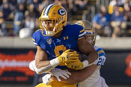 November 25, 2022; Berkeley, California, USA; California Golden Bears running back Jaydn Ott (6) is tackled by UCLA Bruins linebacker Kain Medrano (20) during the second quarter at California Memorial Stadium. Mandatory Credit: Kyle Terada-USA TODAY Sports