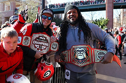 Jan 14, 2023; Athens, GA, USA; Georgia Bulldogs fan and assistant coach Jarvis Jones hold belts at the national championship celebration at Sanford Stadium. Mandatory Credit: Brett Davis-USA TODAY Sports