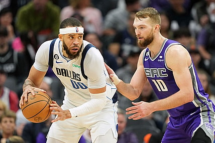 Feb 11, 2023; Sacramento, California, USA; Dallas Mavericks center JaVale McGee (00) handles the ball against Sacramento Kings forward Domantas Sabonis (10) during the third quarter at Golden 1 Center. Mandatory Credit: Darren Yamashita-USA TODAY Sports