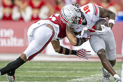 Sep 2, 2023; Bloomington, Indiana, USA; Ohio State Buckeyes wide receiver Marvin Harrison Jr. (18) is tackled by Indiana Hoosiers defensive back Nic Toomer (15) during the first quarter at Memorial Stadium. Mandatory Credit: Marc Lebryk-USA TODAY Sports
