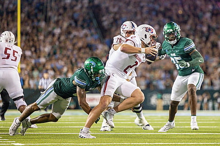 Sep 2, 2023; New Orleans, Louisiana, USA;  South Alabama Jaguars quarterback Carter Bradley (2) scrambles out the pocket to avoid the sack of Tulane Green Wave safety Kam Pedescleaux (8) during the first half at Yulman Stadium. Mandatory Credit: Stephen Lew-USA TODAY Sports