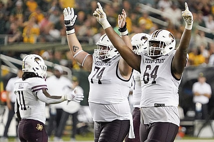 Sep 2, 2023; Waco, Texas, USA; Texas State Bobcats offensive lineman Caleb Johnson (74) and offensive lineman Dorion Strawn (64) celebrate a touchdown against the Baylor Bears during the second half at McLane Stadium. Mandatory Credit: Raymond Carlin III-USA TODAY Sports