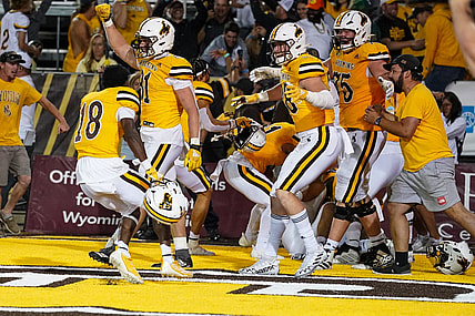 Sep 2, 2023; Laramie, Wyoming, USA; Wyoming Cowboys  rush the field after a double overtime win against the Texas Tech Red Raiders at Jonah Field at War Memorial Stadium. Mandatory Credit: Troy Babbitt-USA TODAY Sports