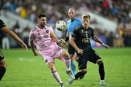 Sep 3, 2023; Los Angeles, California, USA; Inter Miami CF forward Lionel Messi (10) and LAFC midfielder Mateusz Bogusz (19) battle for the ball at BMO Stadium. Mandatory Credit: Kirby Lee-USA TODAY Sports