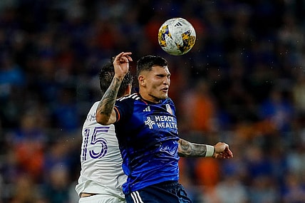 Sep 2, 2023; Cincinnati, Ohio, USA; FC Cincinnati forward Brandon Vazquez (19) heads the ball against Orlando City SC defender Rodrigo Schlegel (15) in the second half at TQL Stadium. Mandatory Credit: Katie Stratman-USA TODAY Sports