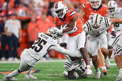 Sep 9, 2023; Syracuse, New York, USA; Syracuse Orange running back Juwaun Price (28) runs with the ball as Western Michigan Broncos cornerback Aaron Wofford (25) defends during the first half at the JMA Wireless Dome. Mandatory Credit: Rich Barnes-USA TODAY Sports